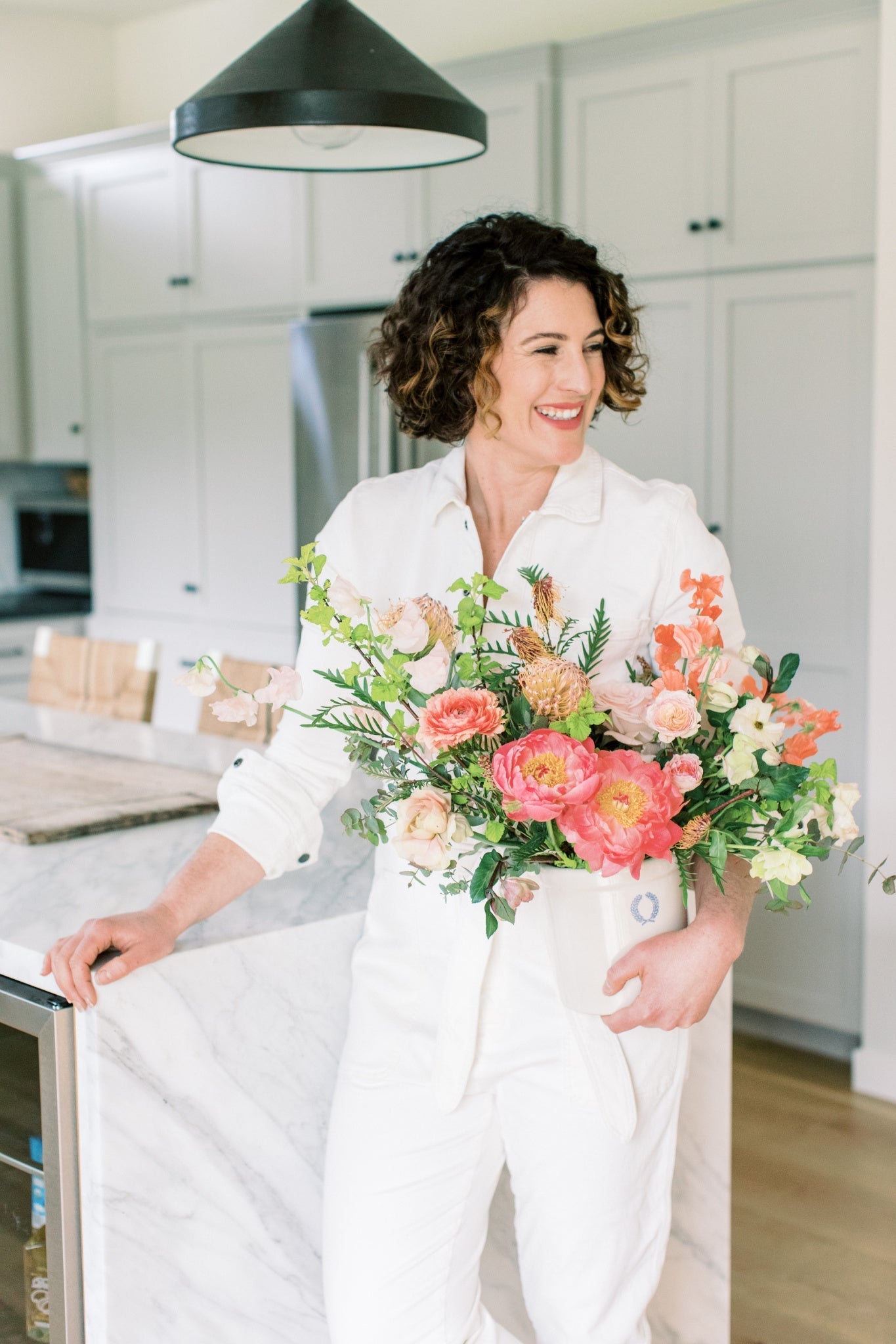 Seascape Flowers holding coral peony bouquet - Shop Santa Cruz Florist for delivery + pickup