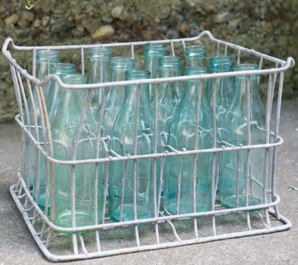 vintage metal milk crate with blue bottles