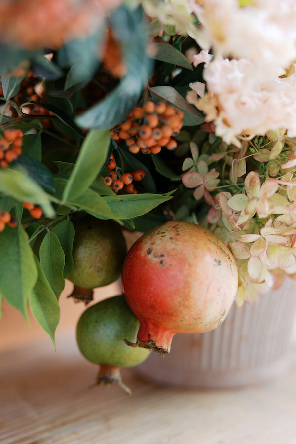pomegranate on fall floral arrangement