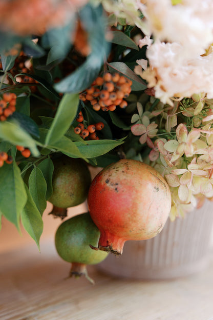 pomegranate on fall floral arrangement