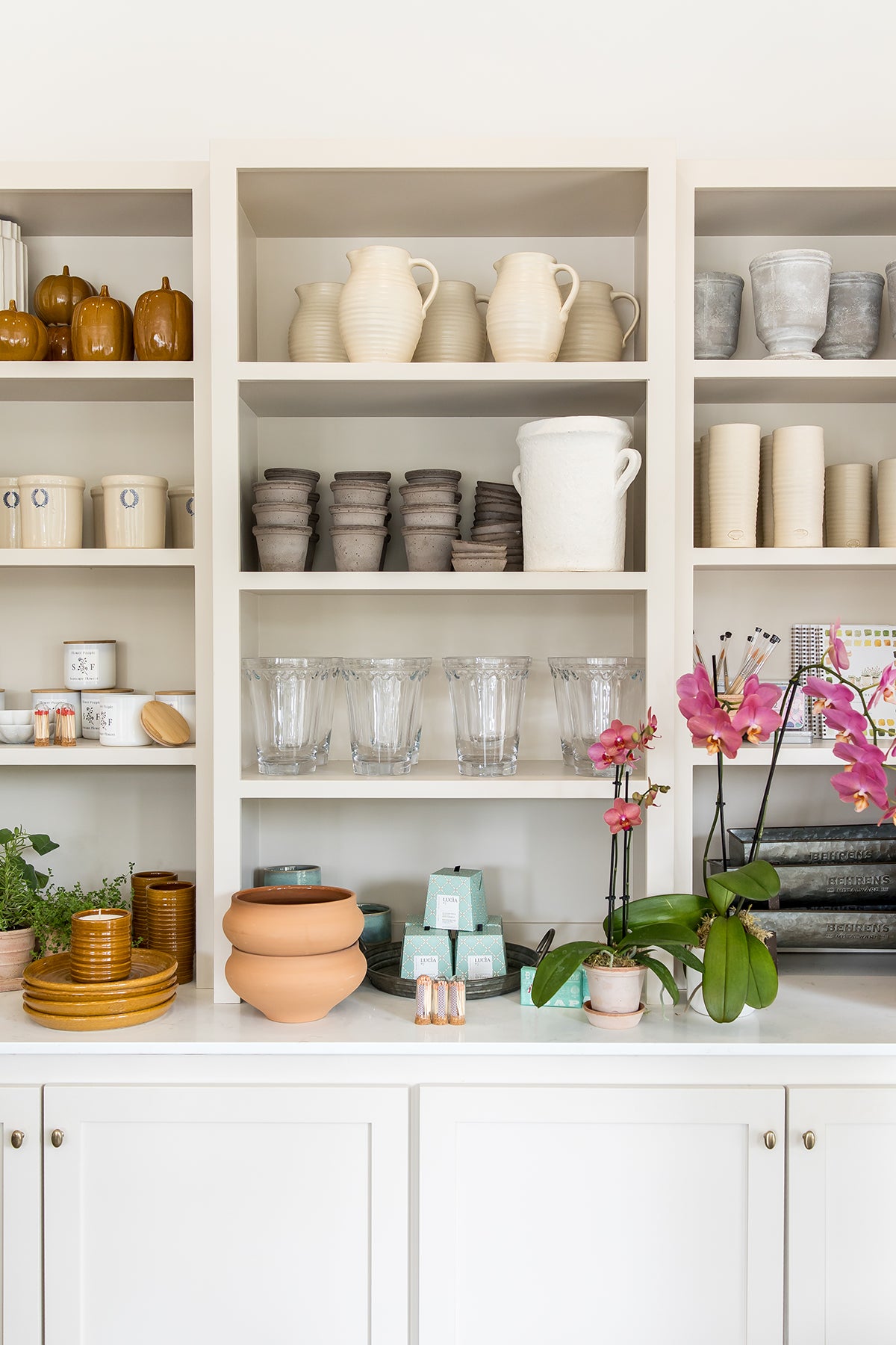Image of pots and home decor on shelves inside Seascape Flowers Aptos flower shop