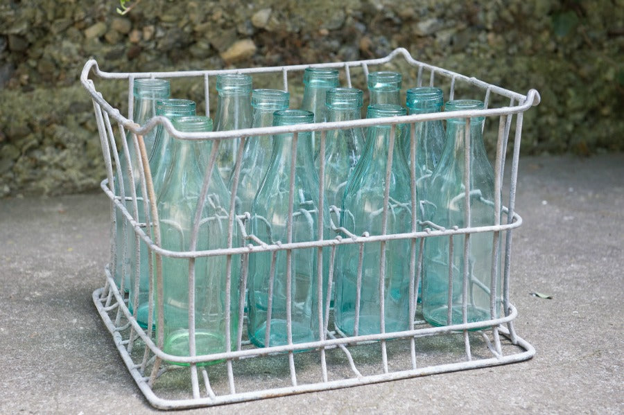 vintage metal milk crate with blue bottles